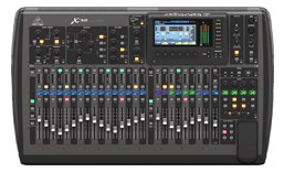 Behringer X32 digital console — top view of the 32-fader surface with screen and channel strips